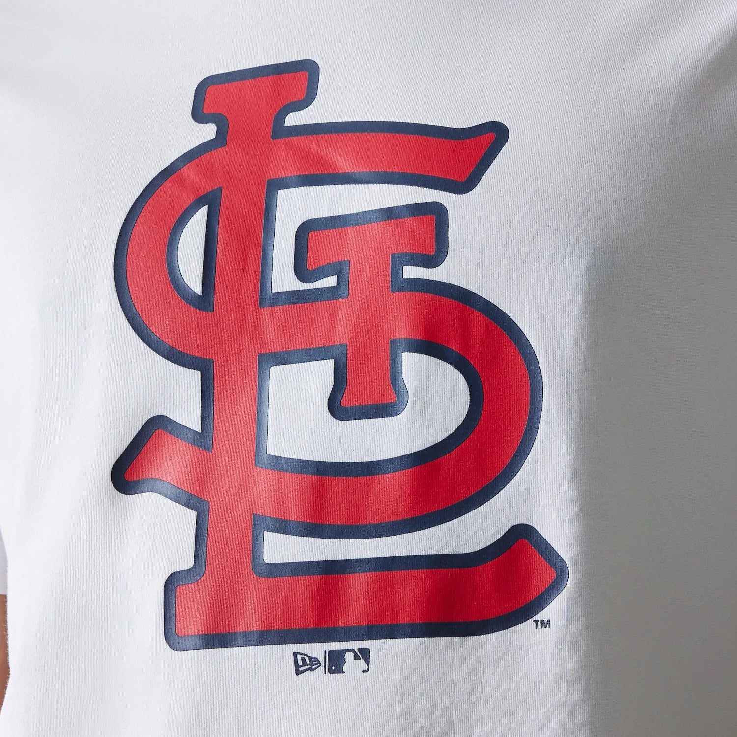 New Era St. Louis Cardinals MLB Regular White T-Shirt, front view showing a large red and blue outlined Cardinals logo centred on the chest, with small embossed New Era and MLB logos near the lower edge.