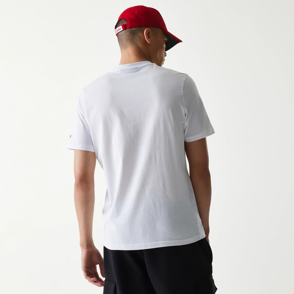 New Era St. Louis Cardinals MLB Regular White T-Shirt, rear view showing the plain white back of the shirt worn by a model, with a red cap featuring a raised New Era logo on the rear of the cap.