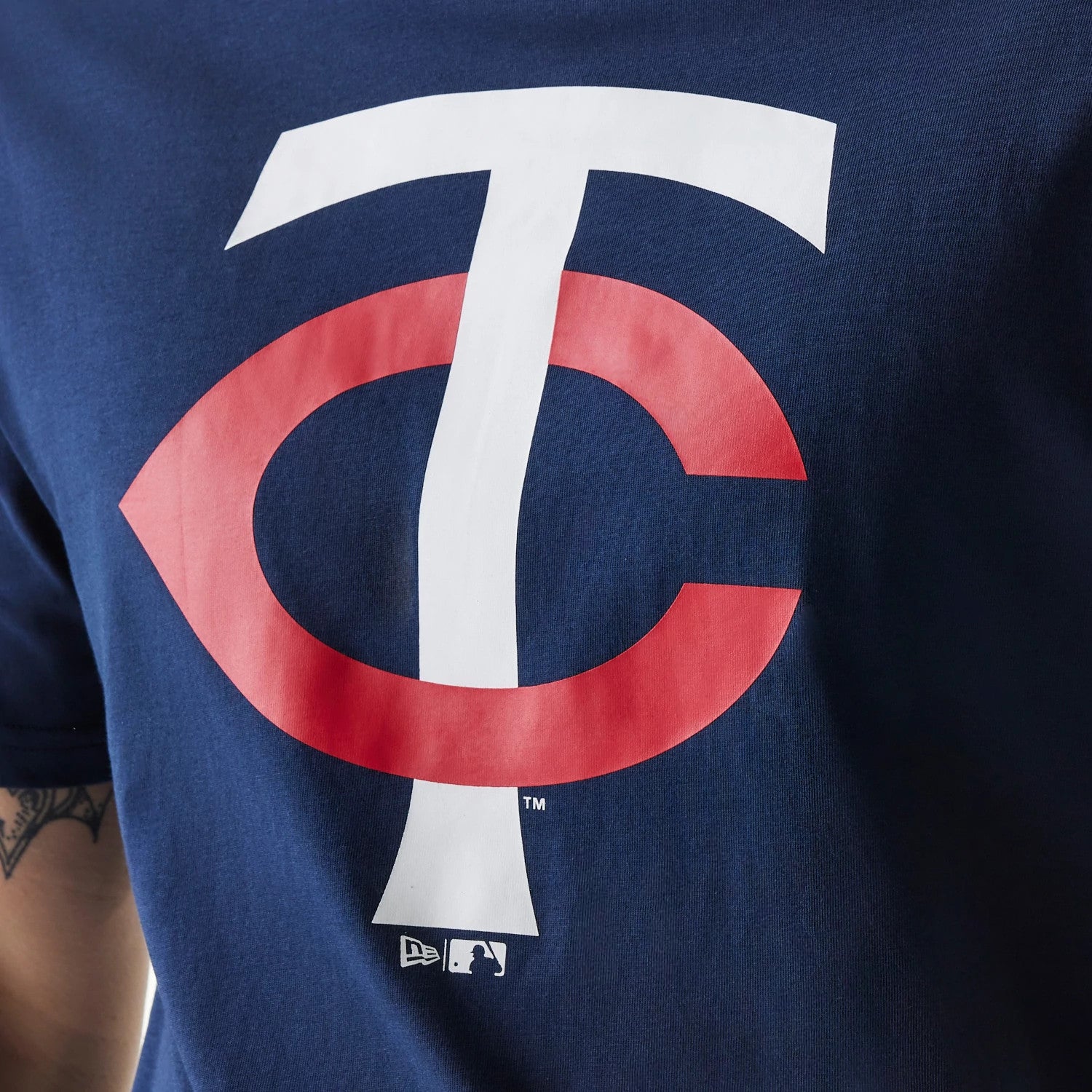 New Era Minnesota Twins MLB Regular Dark Blue T-Shirt, front view showing a large white and red printed logo centred on the chest, with a small white New Era logo and MLB logo at the bottom.