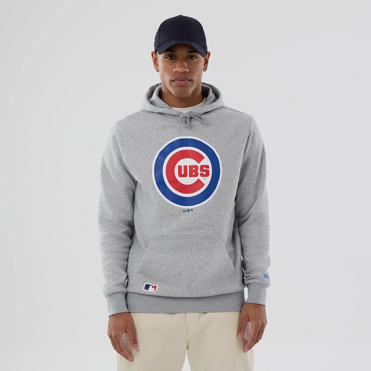 New Era Chicago Cubs MLB Grey Pullover Hoodie, front view showing a large circular Cubs logo in blue and red centred on the chest, a kangaroo pocket below, and a small MLB Batterman logo near the hem on the left side.