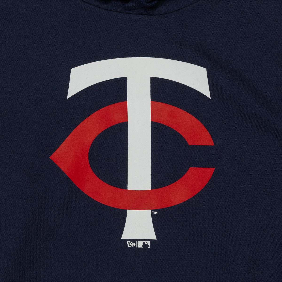 New Era Minnesota Twins MLB Regular Dark Blue Pullover Hoodie, front view displaying the large white and red team logo centred on the dark blue fabric, with a debossed New Era logo and MLB Batterman emblem below the logo.