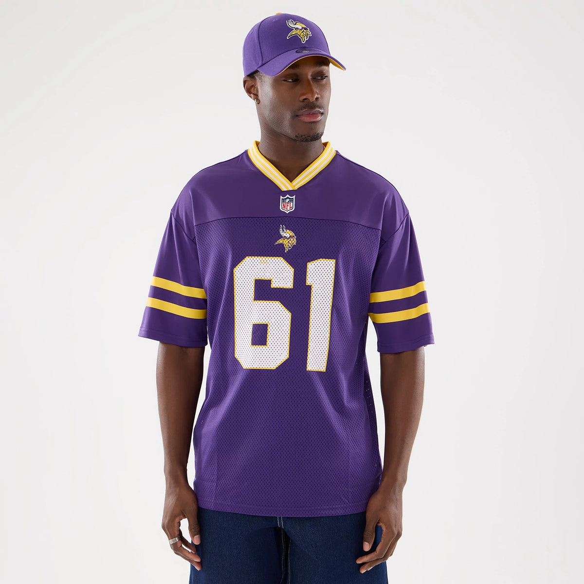 New Era Minnesota Vikings NFL Mesh Purple Mesh Jersey, front view on a model wearing a matching purple cap, features the team's Viking head logo, number 61 in white, and yellow stripes on the sleeves.