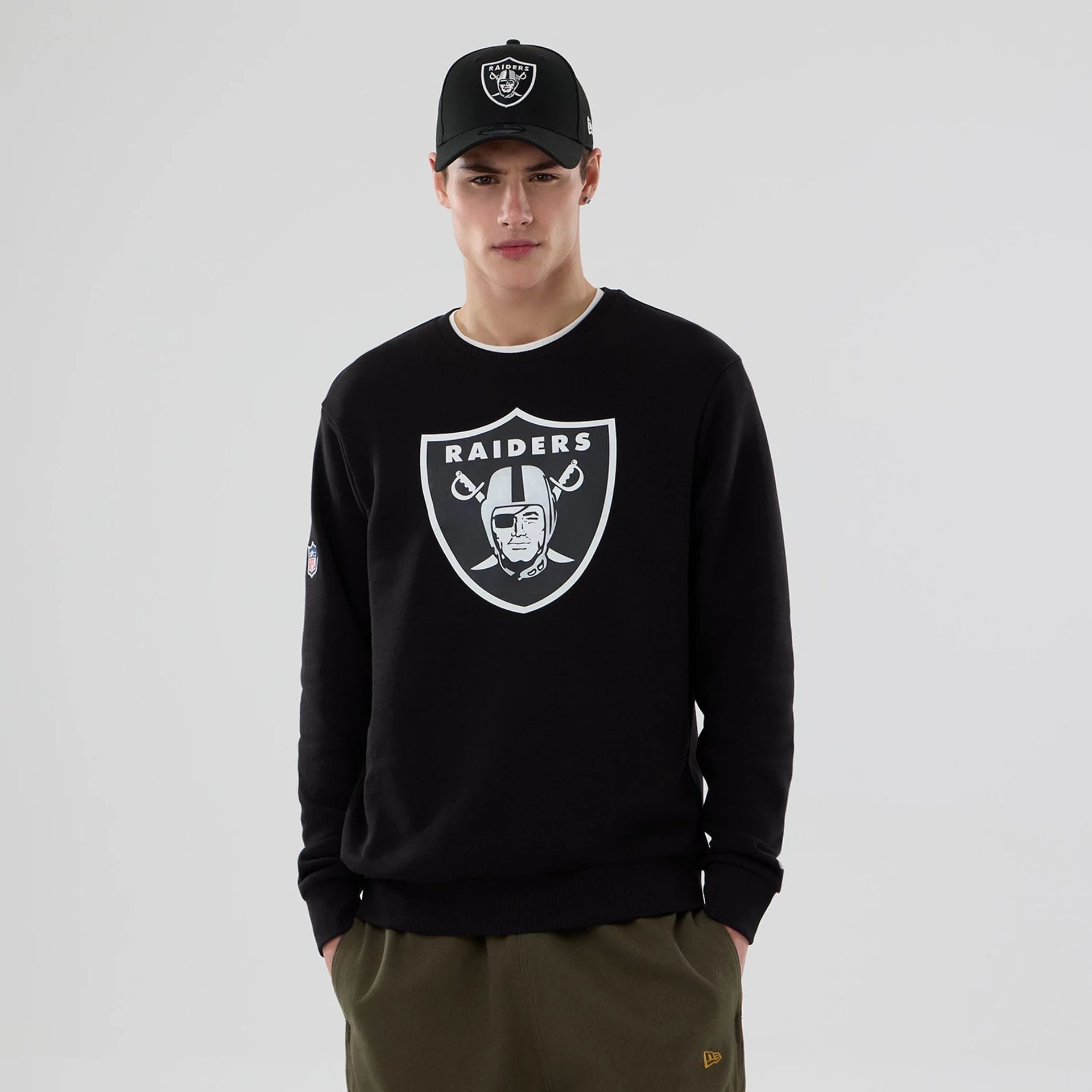 The Male model is wearing Las Vegas Raiders NFL Black Crew Neck Sweater 1