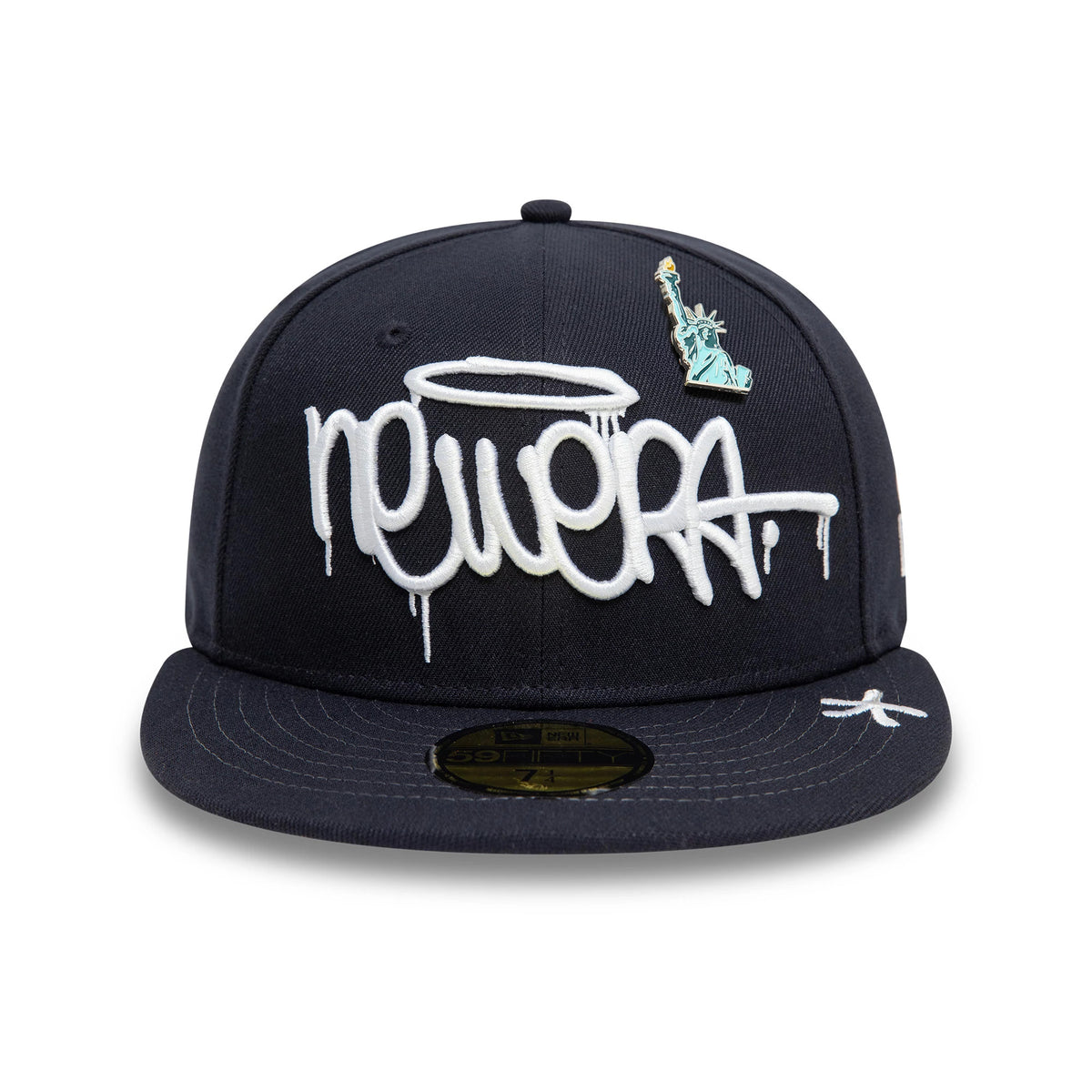 New Era Graphic Navy New Era 59FIFTY Fitted Cap, front view showing raised white new era embroidery with drip effect, a Statue of Liberty pin on the front panel, and a gold 59FIFTY size sticker on the flat navy visor.