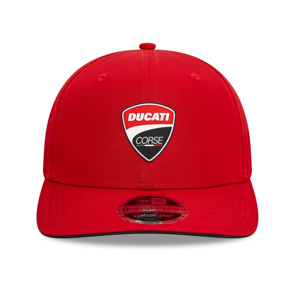 Ducati Motor Logo Core Red New Era 9SEVENTY Stretch Snap Adjustable Cap, front view showing the Ducati Corse badge centred on the red crown with a curved visor and transparent 9SEVENTY size sticker on top.