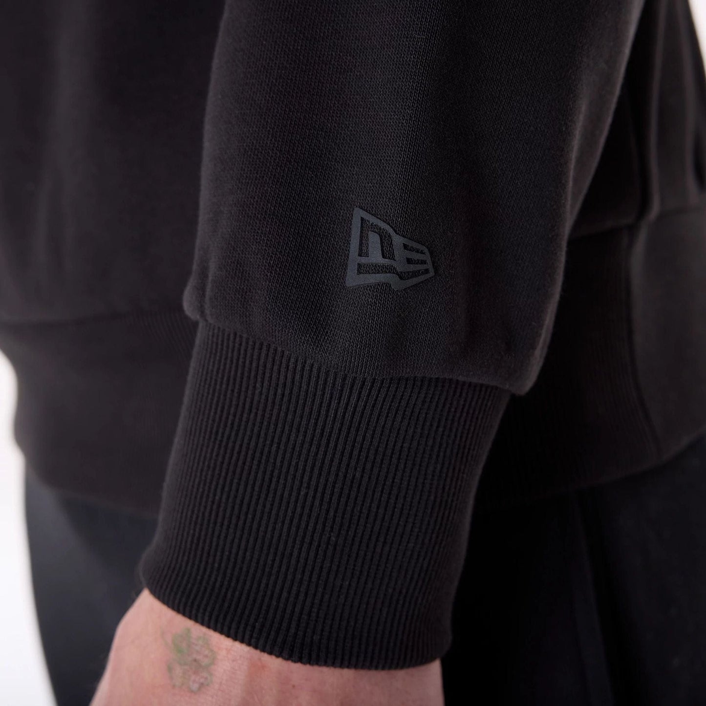 The Male model is wearing New Era Flag Black Oversized Pullover Hoodie 7