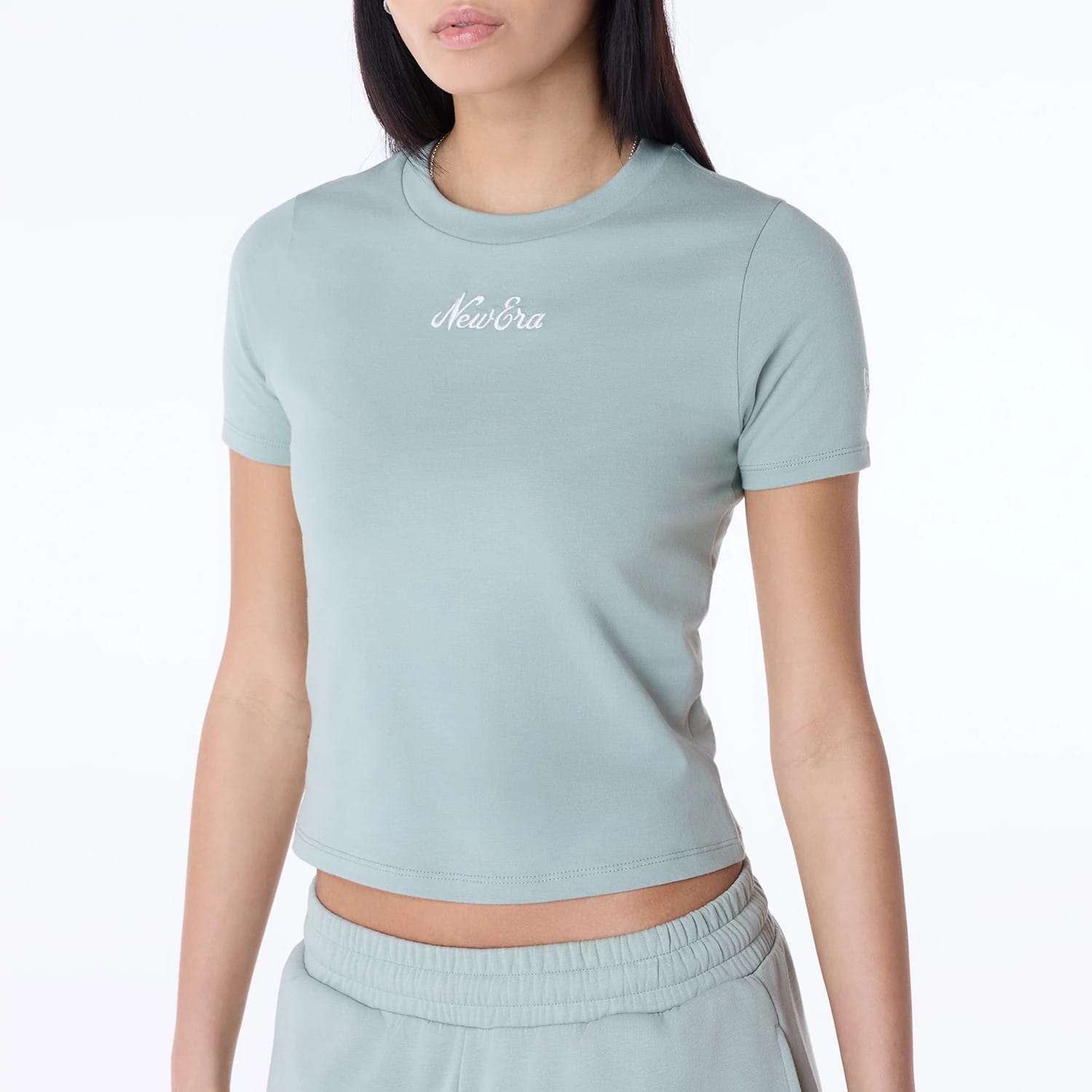 The Female model is wearing Womens New Era Slim Pastel Blue T-Shirt 2
