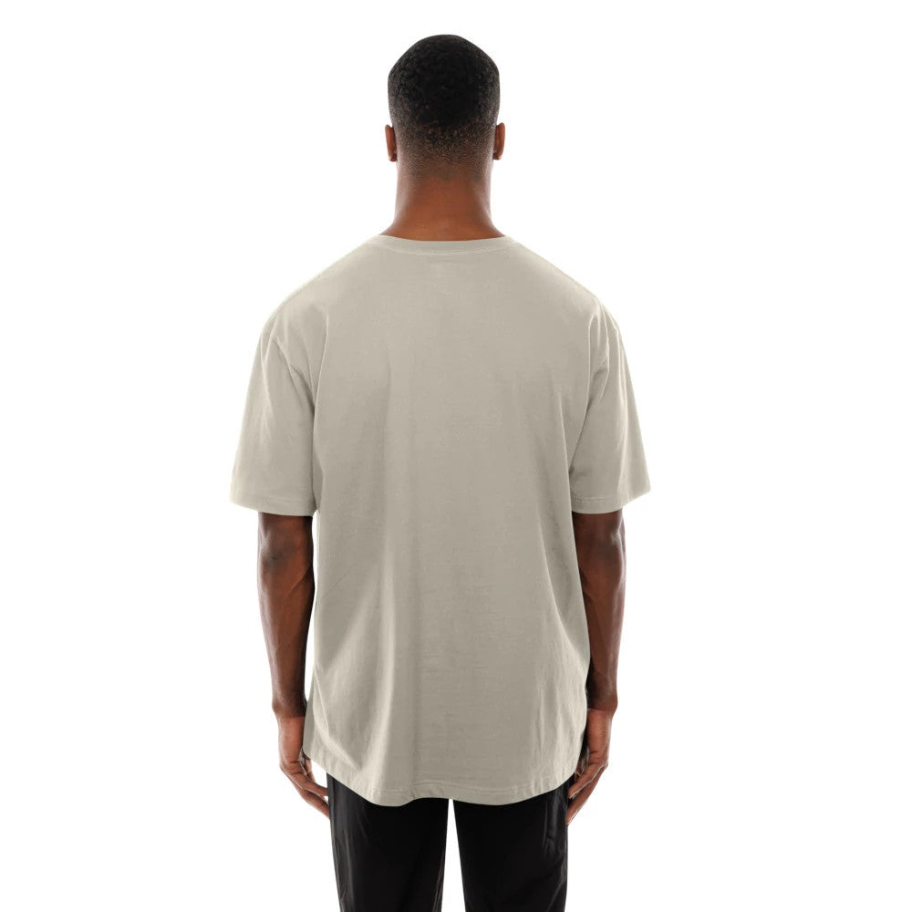 New Era Miami Heat Modern Driver Light Beige T-Shirt, rear view showing the plain light beige back with short sleeves, set against the straight shoulder line and the relaxed fit extending to the curved hem.