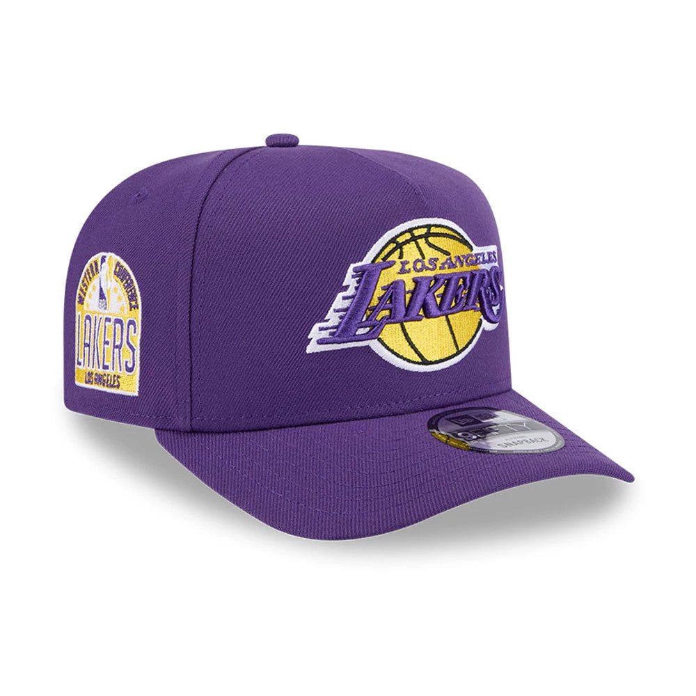 LA Lakers NBA Evergreen Purple New Era 9FIFTY A-Frame Snapback Adjustable Cap, three-quarter view showing the raised embroidered Lakers logo in yellow and purple on the front panel, with a black and white 9FIFTY size sticker on the purple visor.