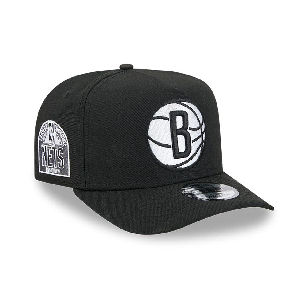 Brooklyn Nets NBA Evergreen Black New Era 9FIFTY A-Frame Snapback Adjustable Cap, three-quarter view with the white embroidered B logo on the front panel, Eastern Conference patch on the right side, and the 9FIFTY size sticker on the black visor.
