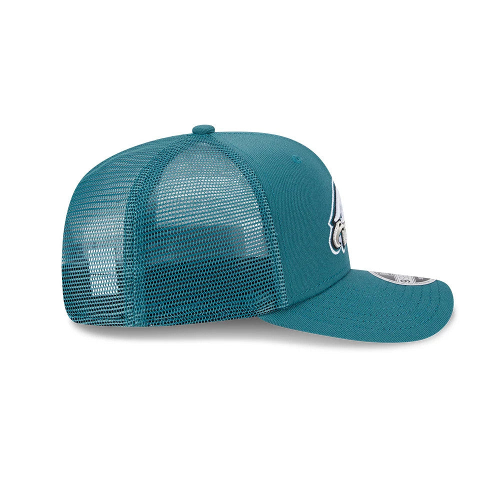 Philadelphia Eagles NFL Evergreen Dark Green New Era 9SEVENTY Stretch Snap Cap, side view with mesh back panels, raised embroidered Eagles logo on the front panel, and a curved visor featuring the 9SEVENTY size sticker.