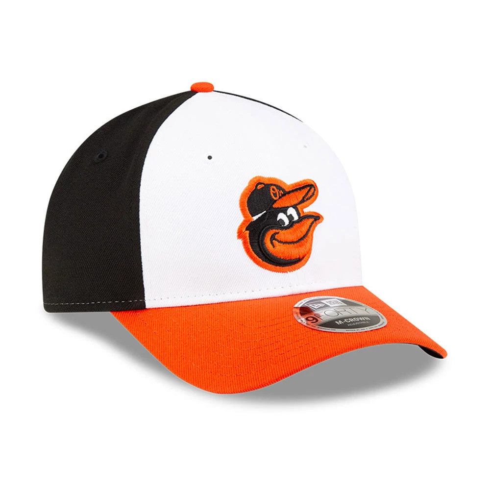 Baltimore Orioles MLB Player Replica White New Era 9FORTY M-Crown Adjustable Cap, front view with the black and orange Orioles logo embroidered on the white front panel, an orange visor, and a 9FORTY size sticker on top.