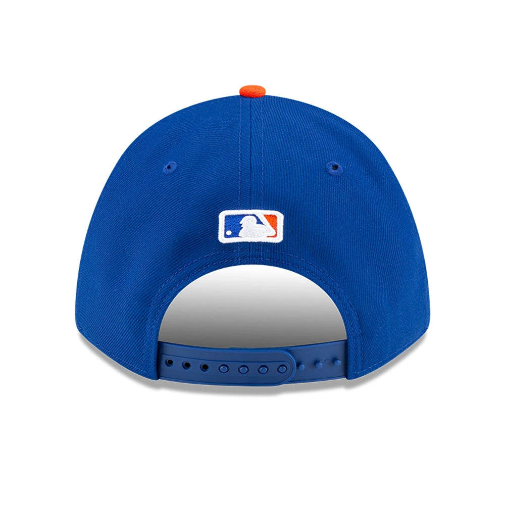 New York Mets MLB Player Replica Blue New Era 9FORTY M-Crown Adjustable Cap, rear view showing the embroidered MLB Batterman logo at the centre back of the structured blue crown, with an orange top button and adjustable snap closure.