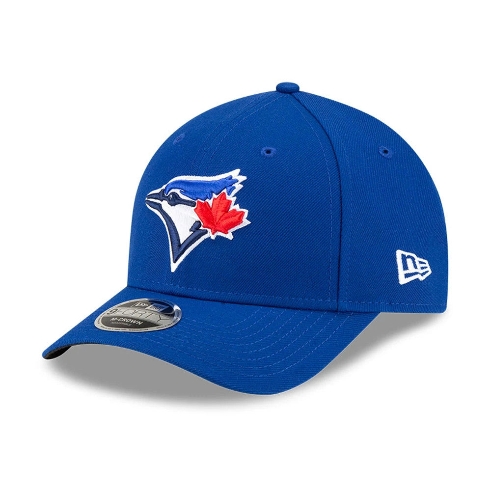 Toronto Blue Jays MLB Player Replica Blue New Era 9FORTY M-Crown Adjustable Cap, three-quarter view showing the Blue Jays logo with a red maple leaf on the front panel, curved visor with a 9FORTY size sticker, and New Era flag logo on the left side.