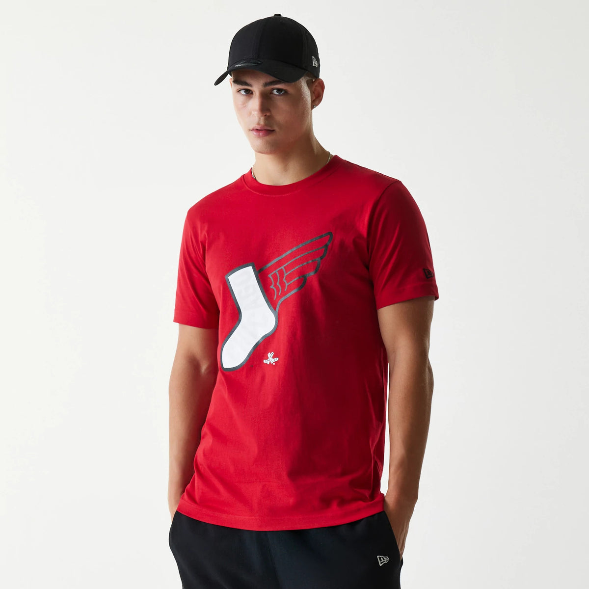 New Era Chicago White Sox MLB City Connect 2025 Red T-Shirt, on-model view showing a red tee with a winged white sock graphic on the front, and a small debossed New Era logo on the sleeve.