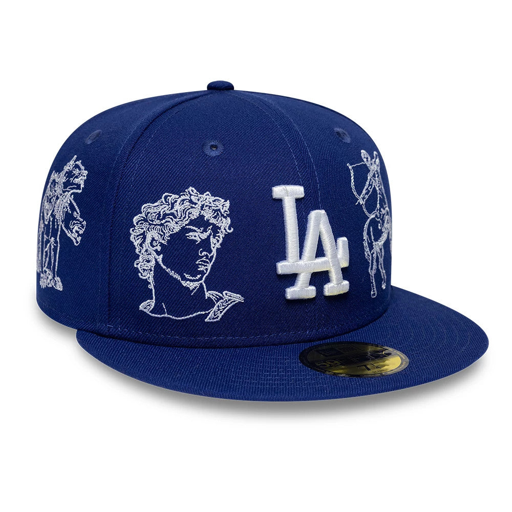 LA Dodgers MLB Mythical Dark Blue New Era 59FIFTY FItted Cap, three-quarter view showing the white raised embroidered LA logo, mythical creature graphics on the panels, and a gold 59FIFTY size sticker on the flat visor.