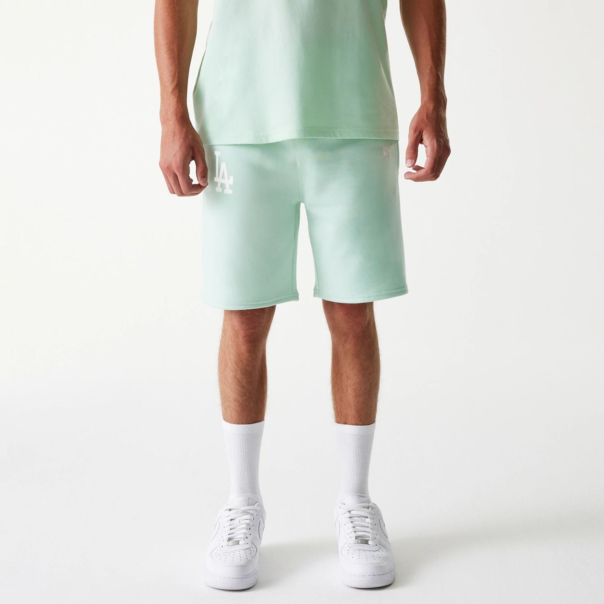 The Male model is wearing LA Dodgers MLB League Essential Pastel Green Shorts 1
