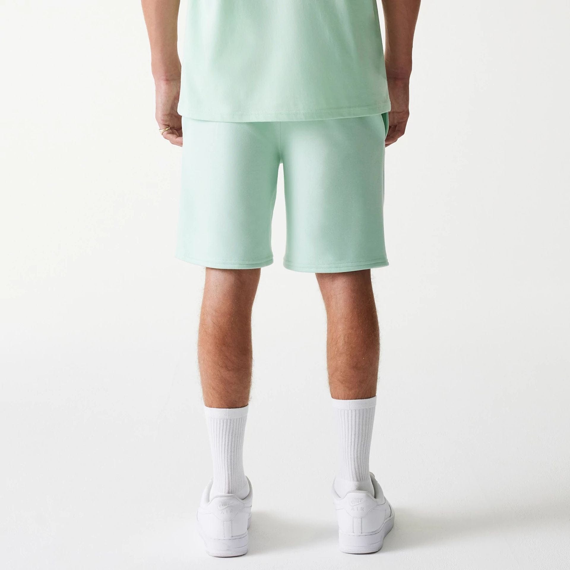 The Male model is wearing LA Dodgers MLB League Essential Pastel Green Shorts 2