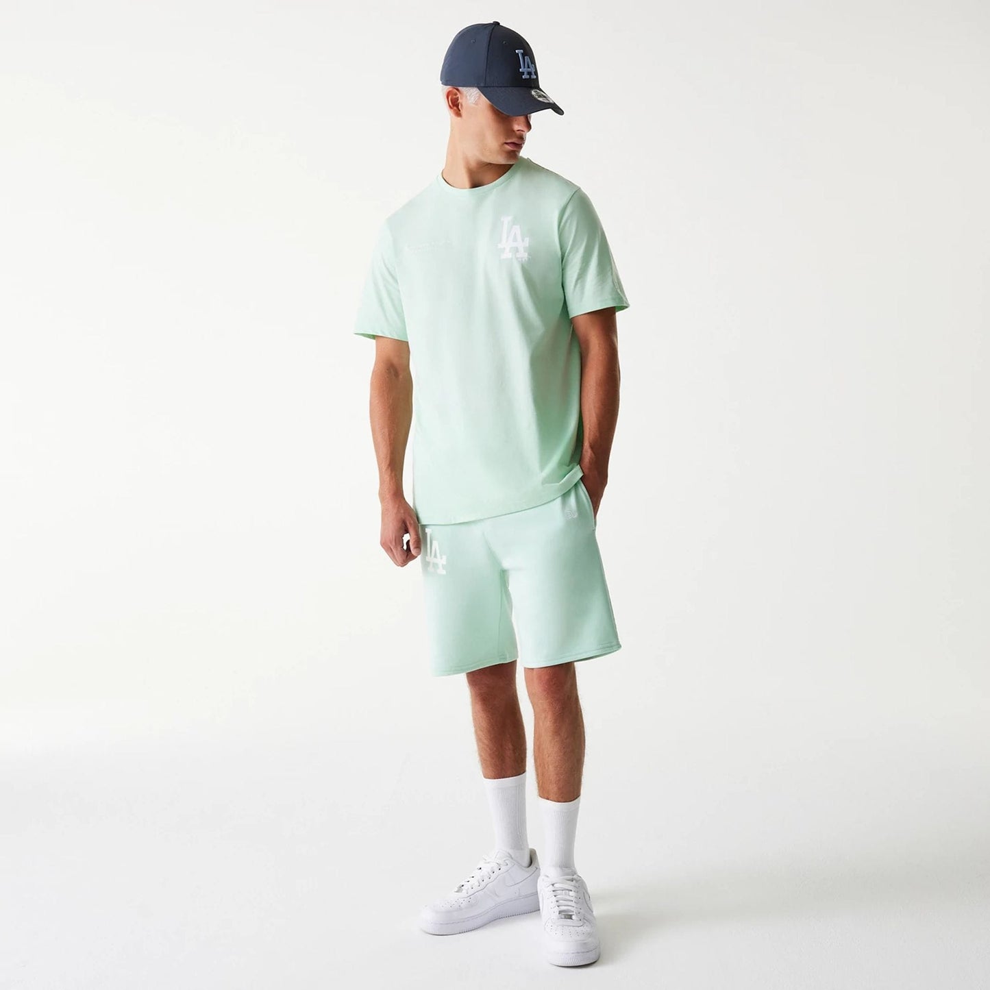 The Male model is wearing LA Dodgers MLB League Essential Pastel Green Shorts 8