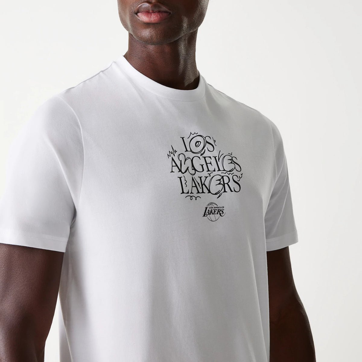 New Era LA Lakers NBA Court Graphic White T-Shirt, three-quarter view showcasing the wide round neckline and short sleeves, with a large black graphic print of Los Angeles Lakers and a debossed Lakers logo on the chest.