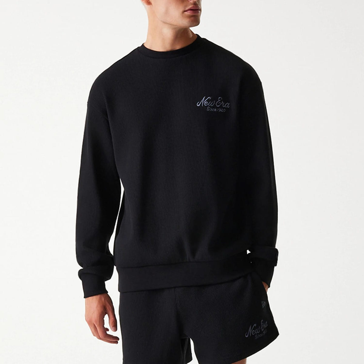 The Male model is wearing New Era Waffle Black Oversized Crew Neck Sweater 3