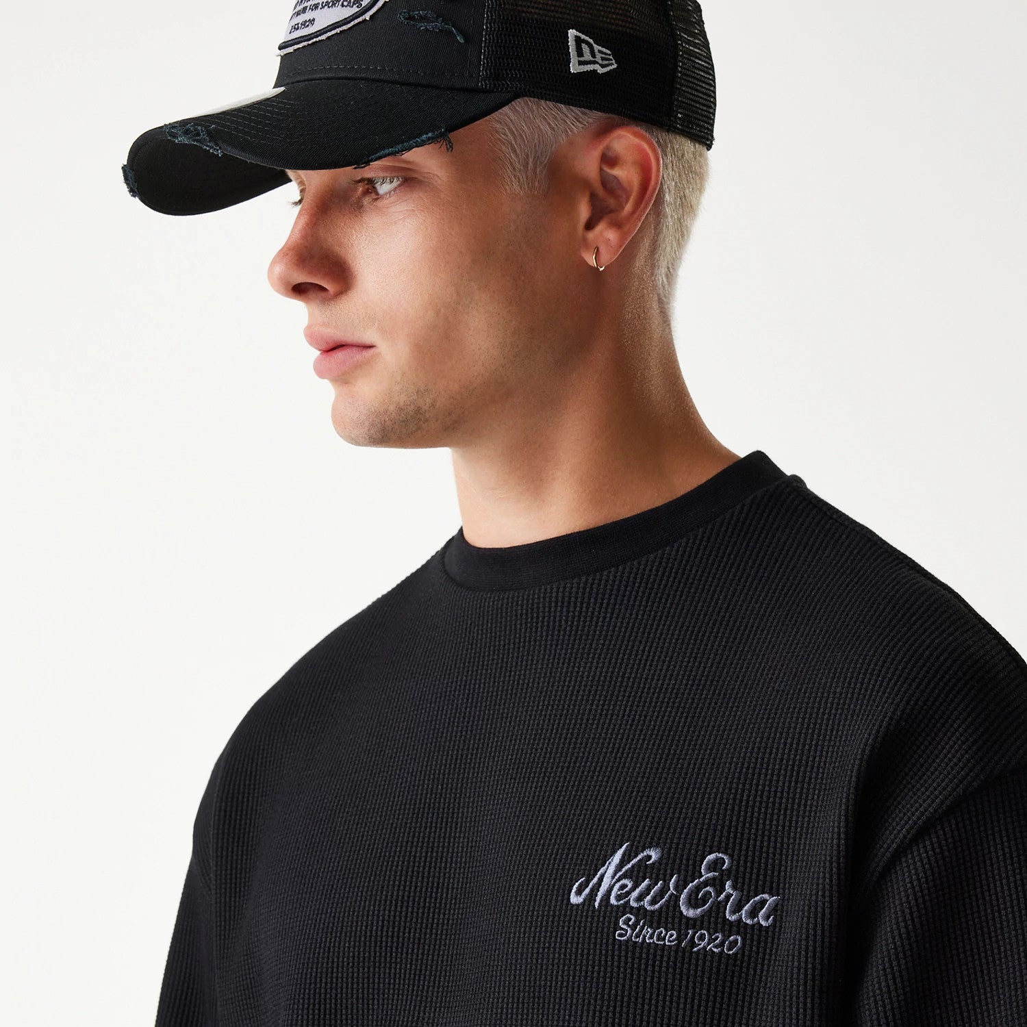 The Male model is wearing New Era Waffle Black Oversized Crew Neck Sweater 4