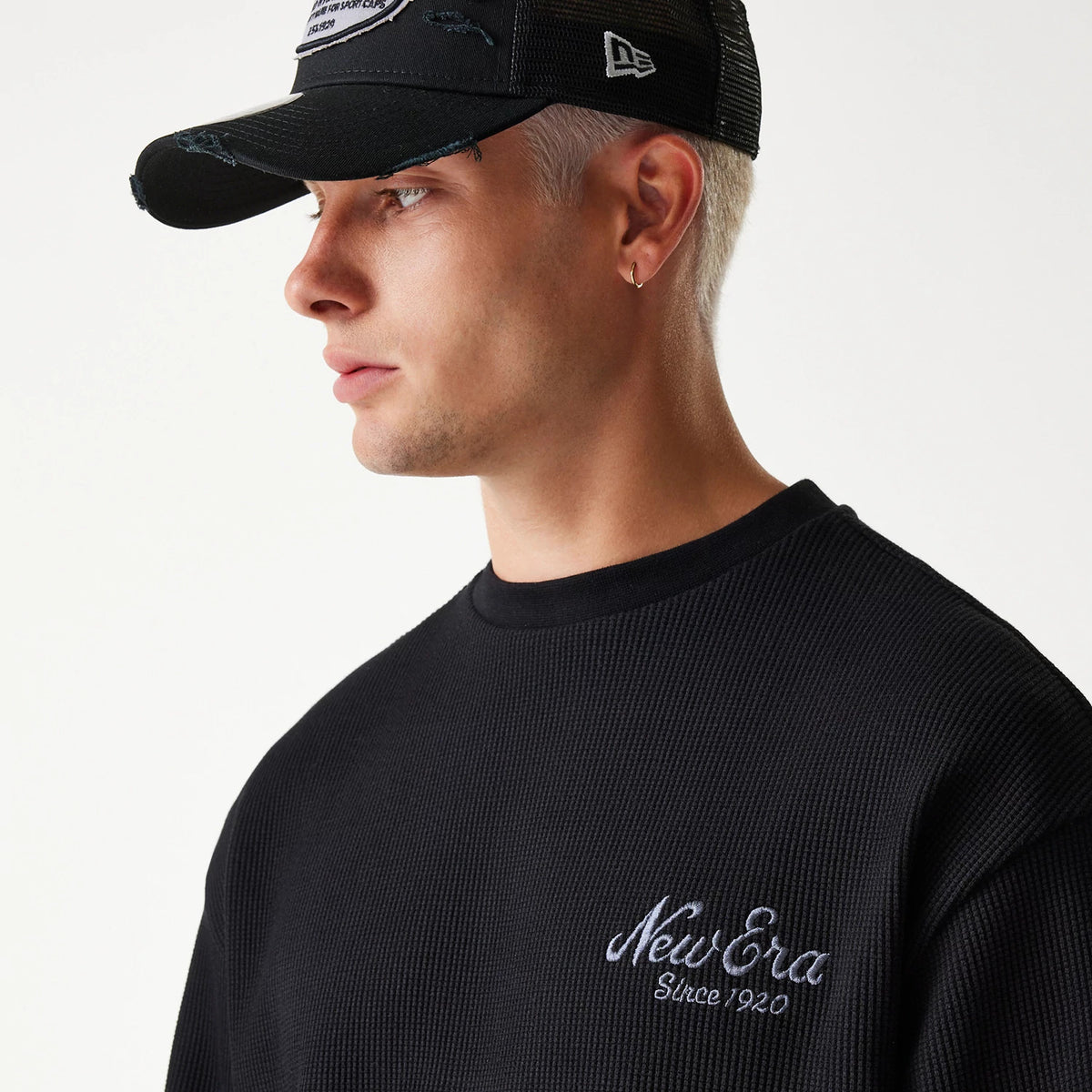 The Male model is wearing New Era Waffle Black Oversized Crew Neck Sweater 4