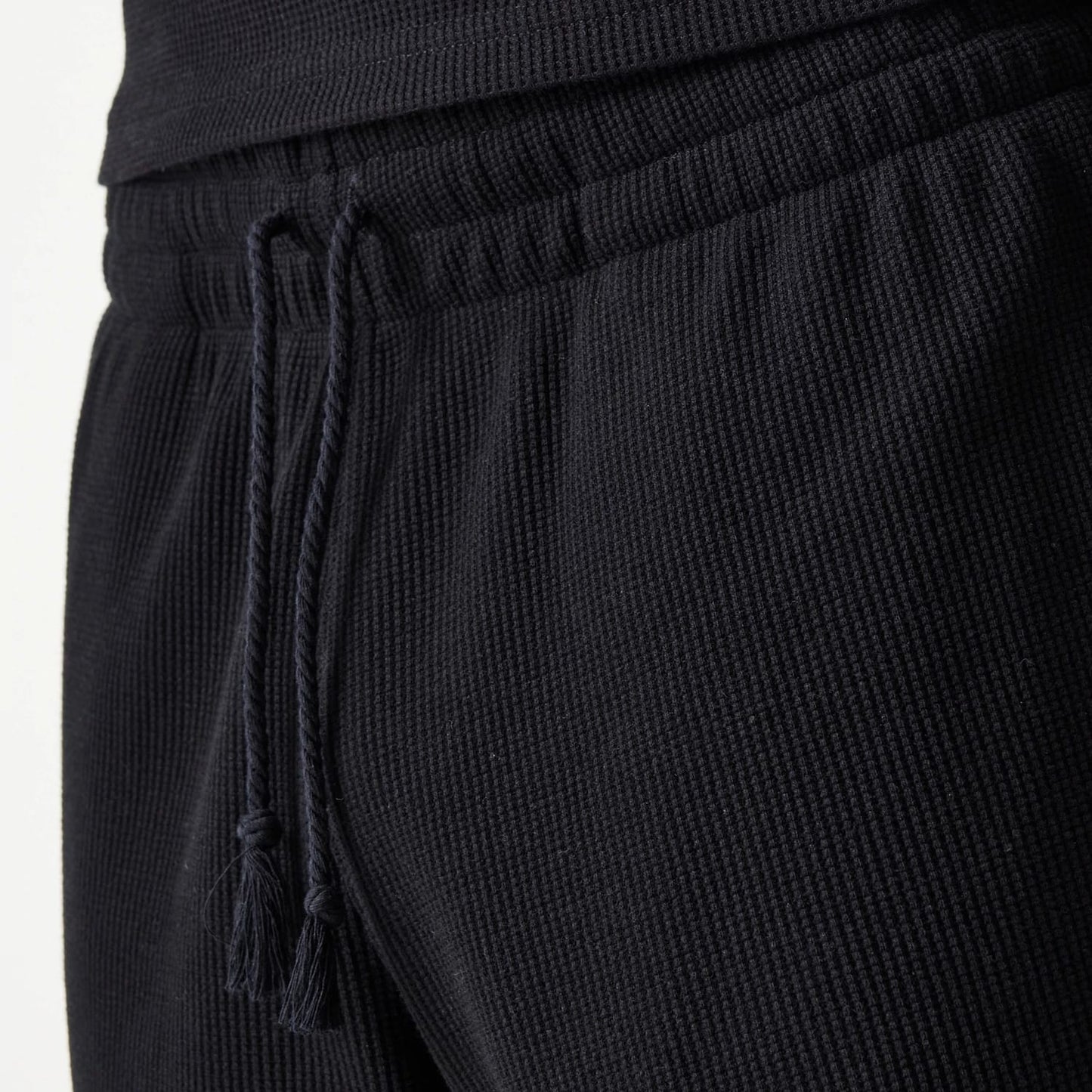 The Male model is wearing New Era Waffle Black Shorts 8