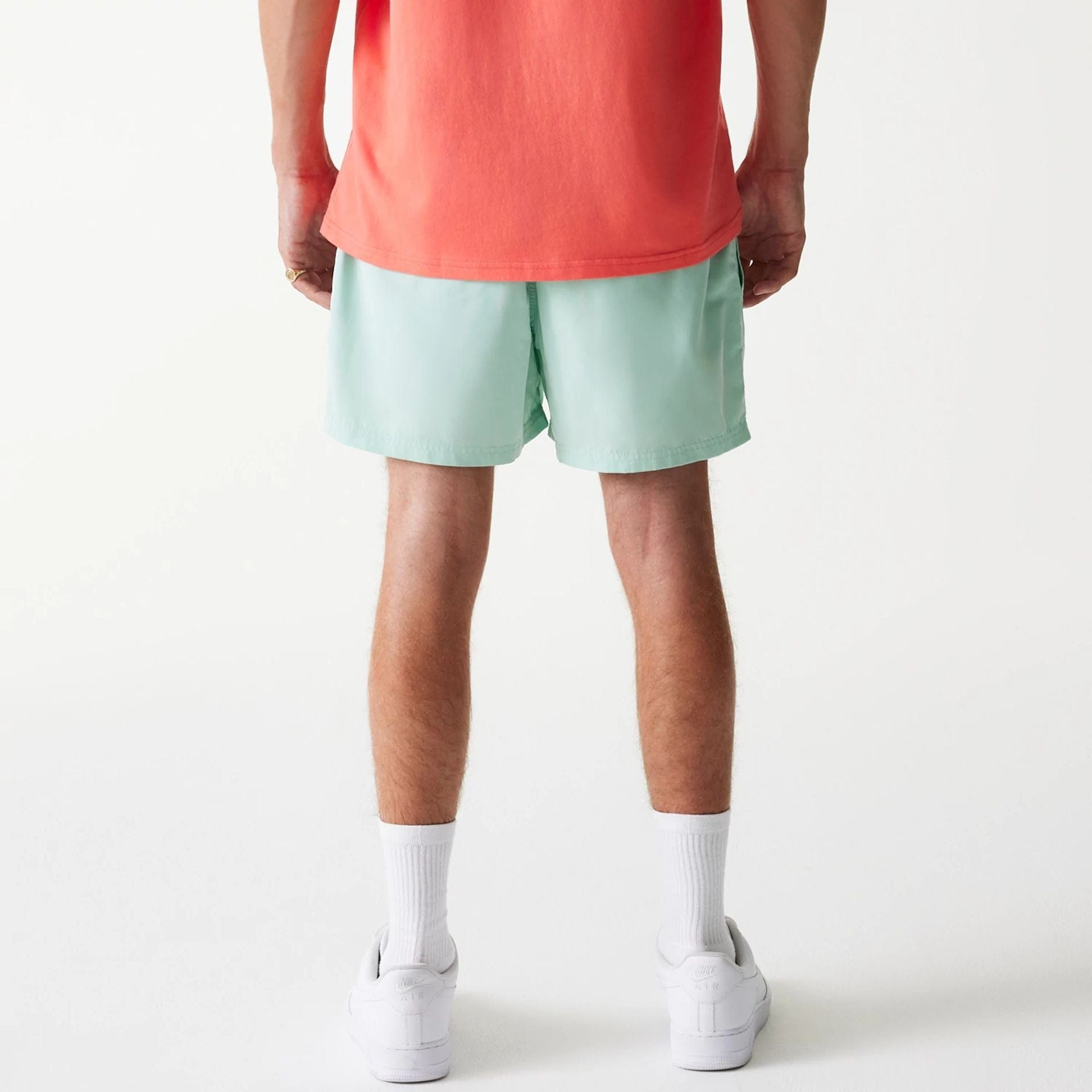 The Male model is wearing New Era Pastel Green Swim Shorts 2
