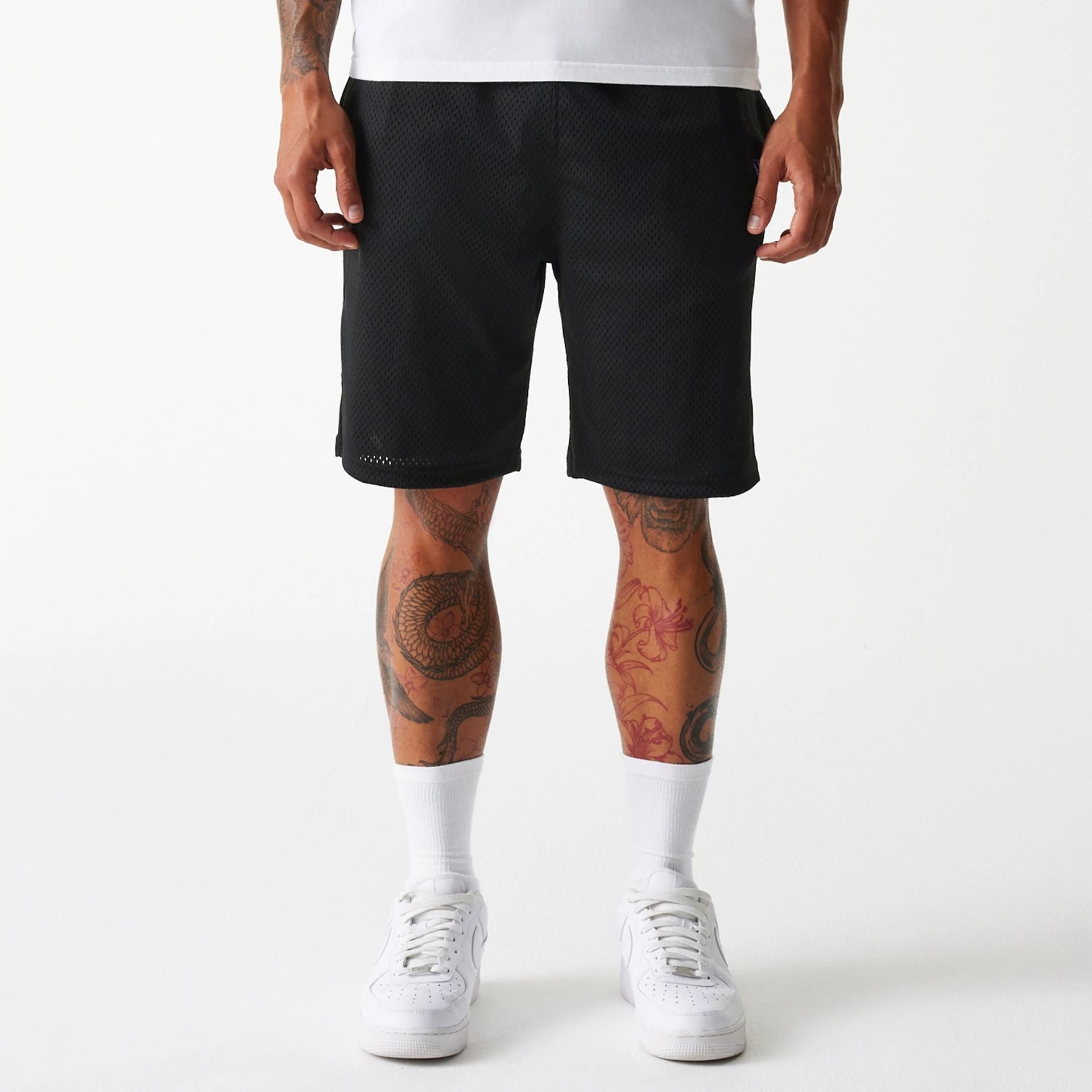 The Male model is wearing New Era Black Mesh Shorts 1