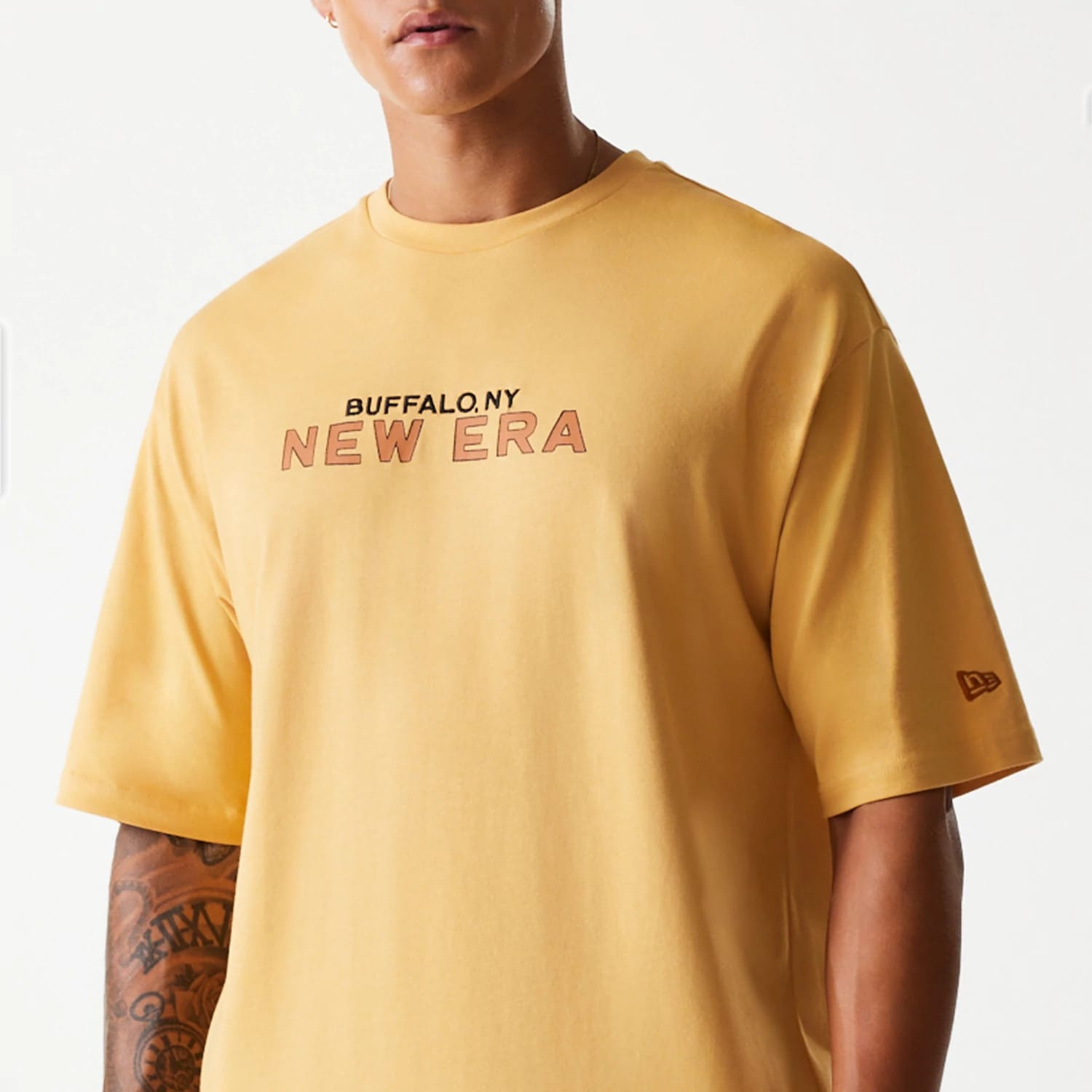 The Male model is wearing New Era Vacation Graphic Beige Oversized T-Shirt 3