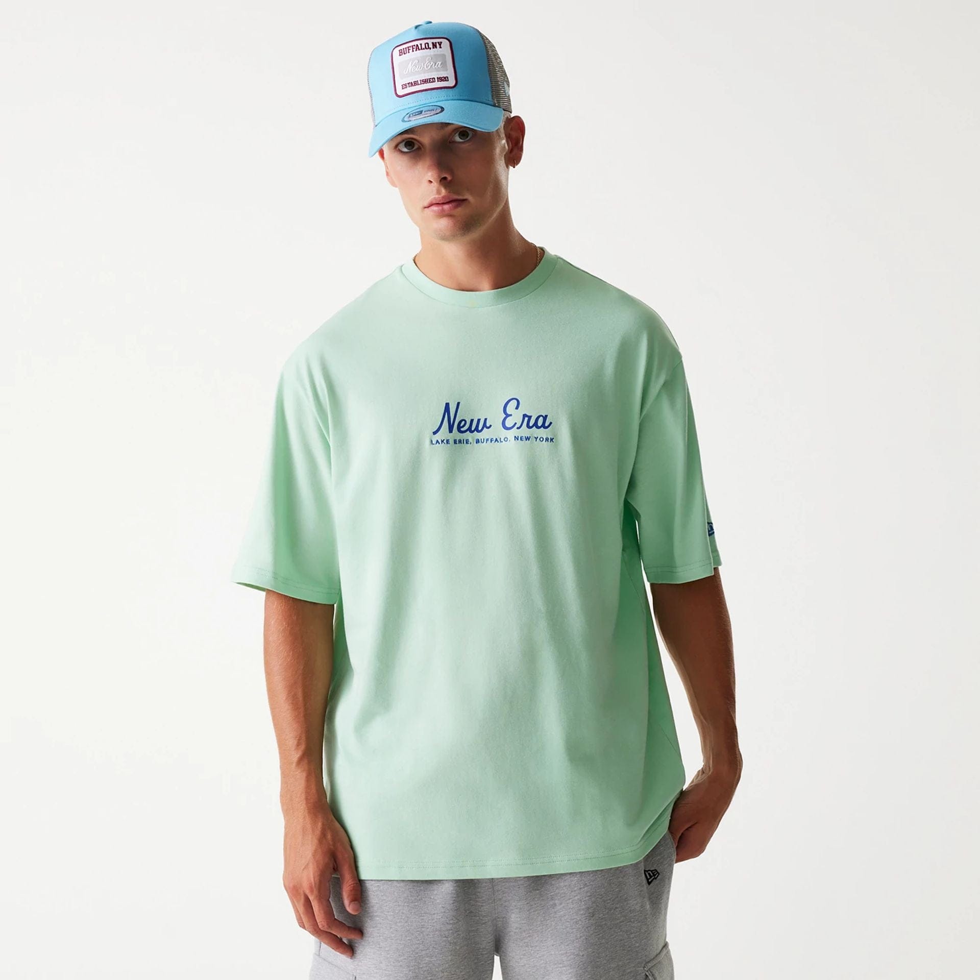 The Male model is wearing New Era Vacation Graphic Pastel Green Oversized T-Shirt 2