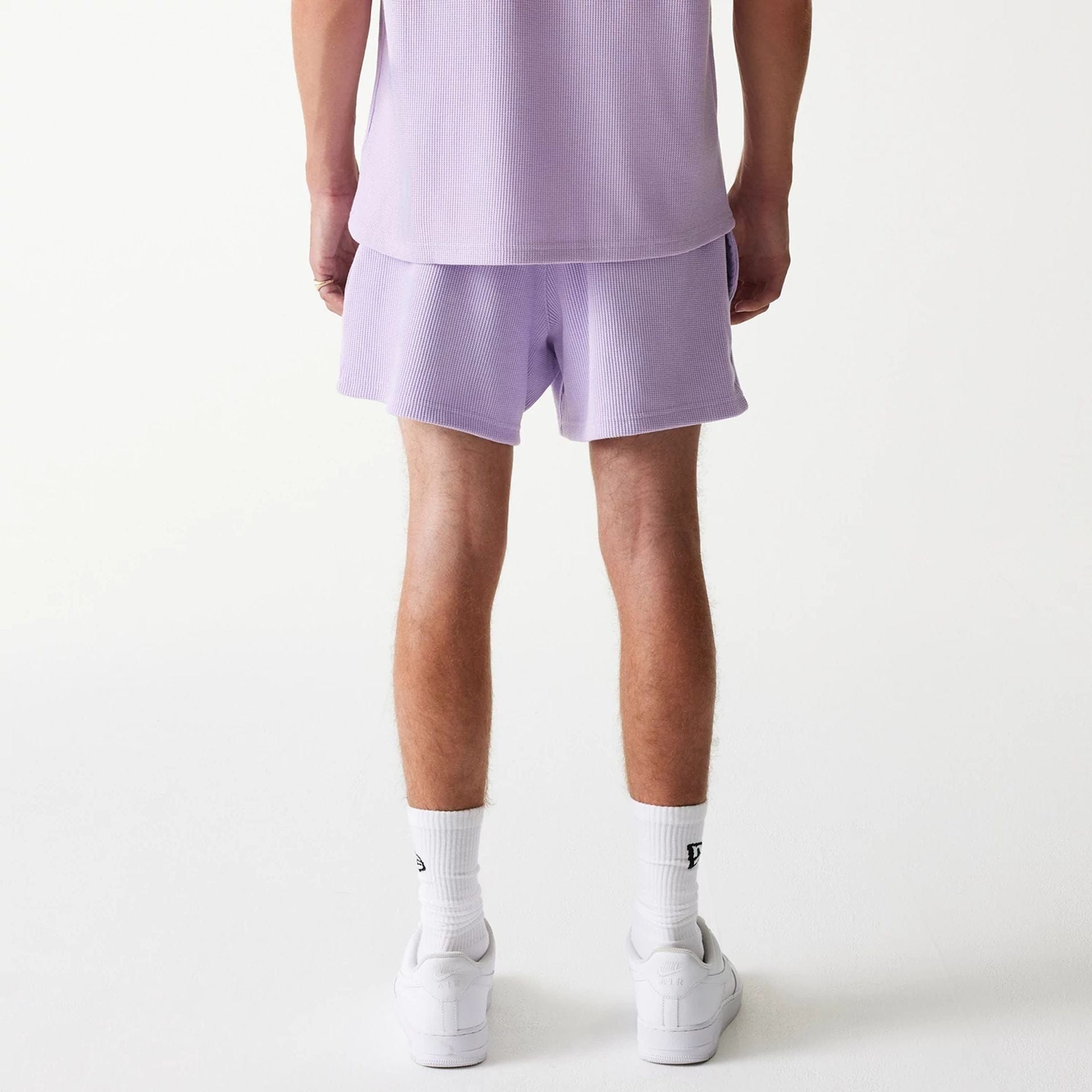The Male model is wearing New Era Waffle Pastel Purple Shorts 2