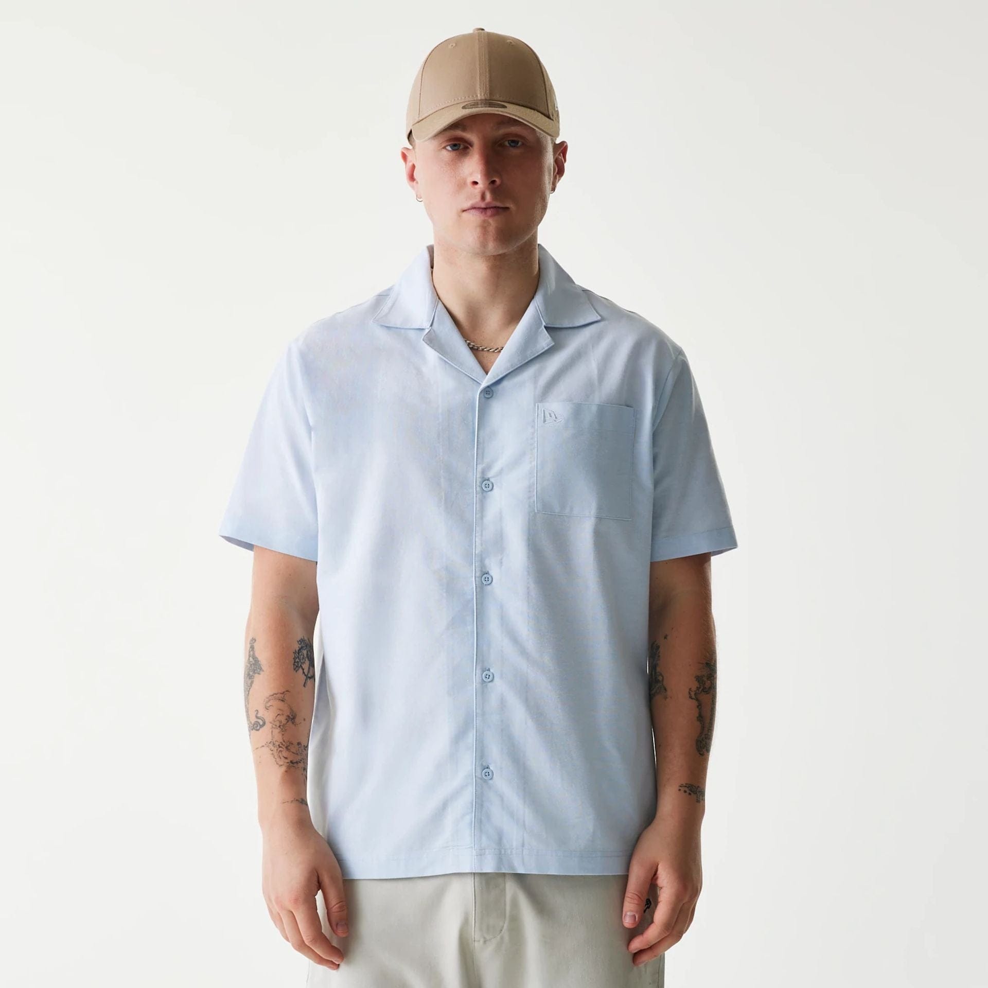 The Male model is wearing New Era Pastel Blue Revere Short Sleeve Shirt 1