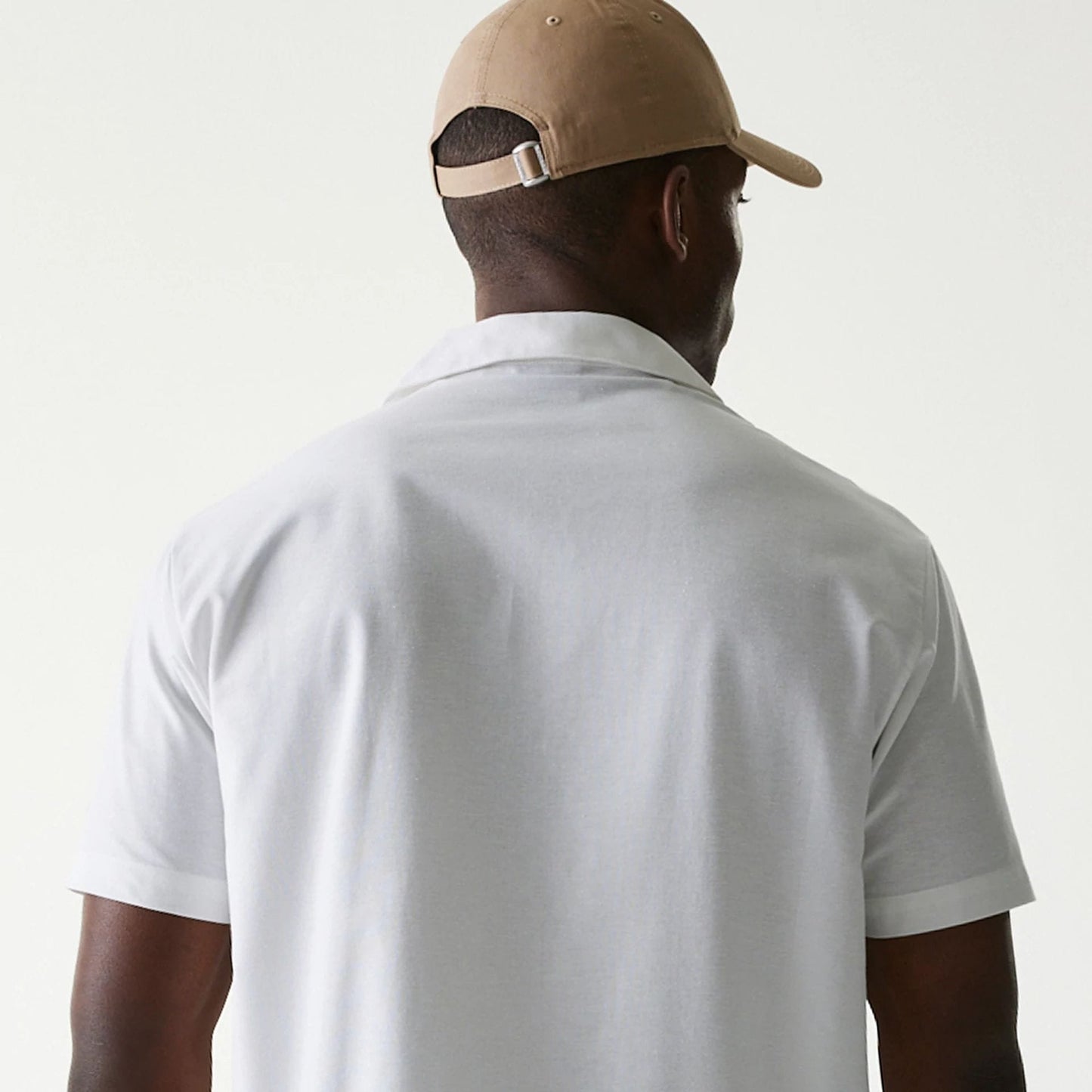 The Male model is wearing New Era White Revere Short Sleeve Shirt 7