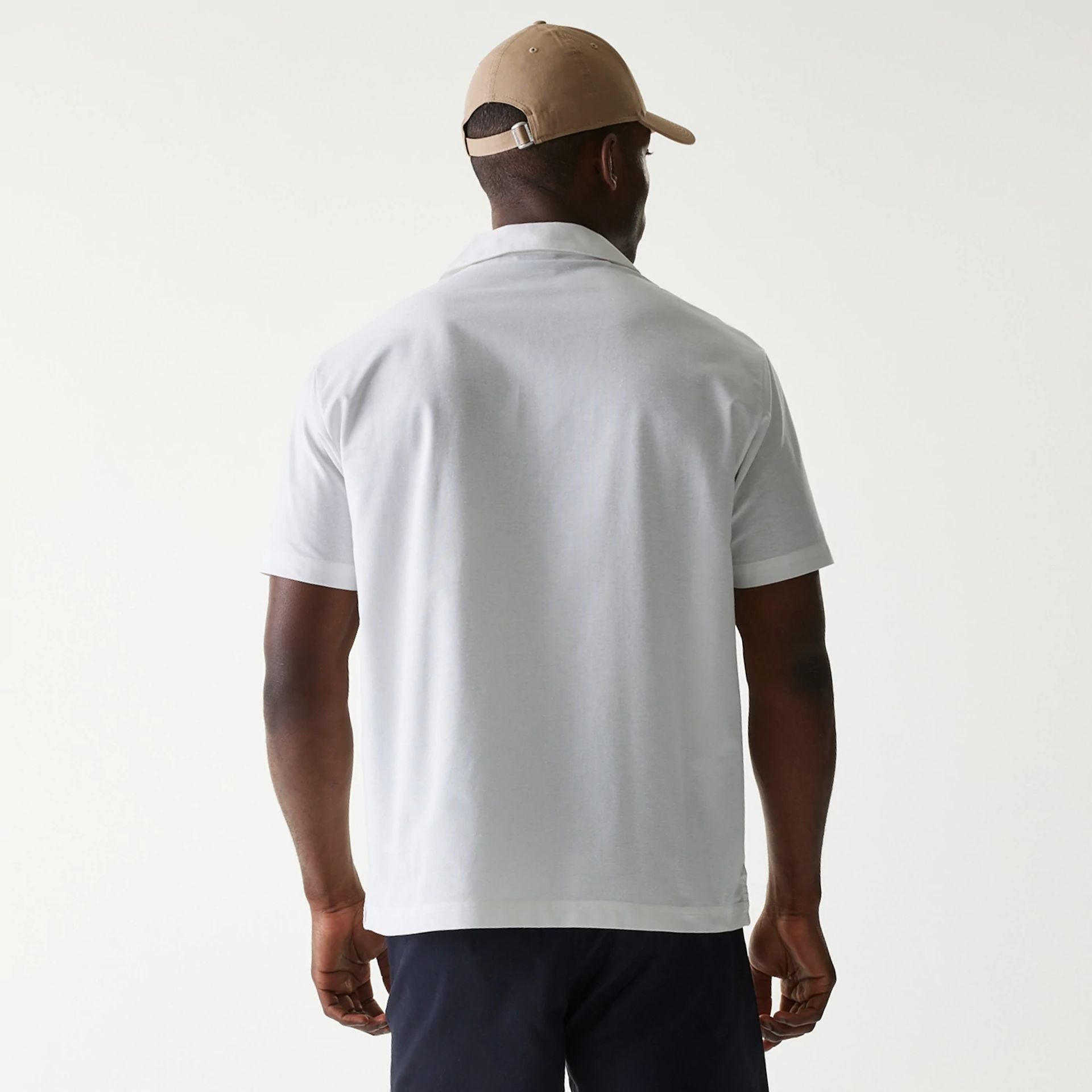 The Male model is wearing New Era White Revere Short Sleeve Shirt 2