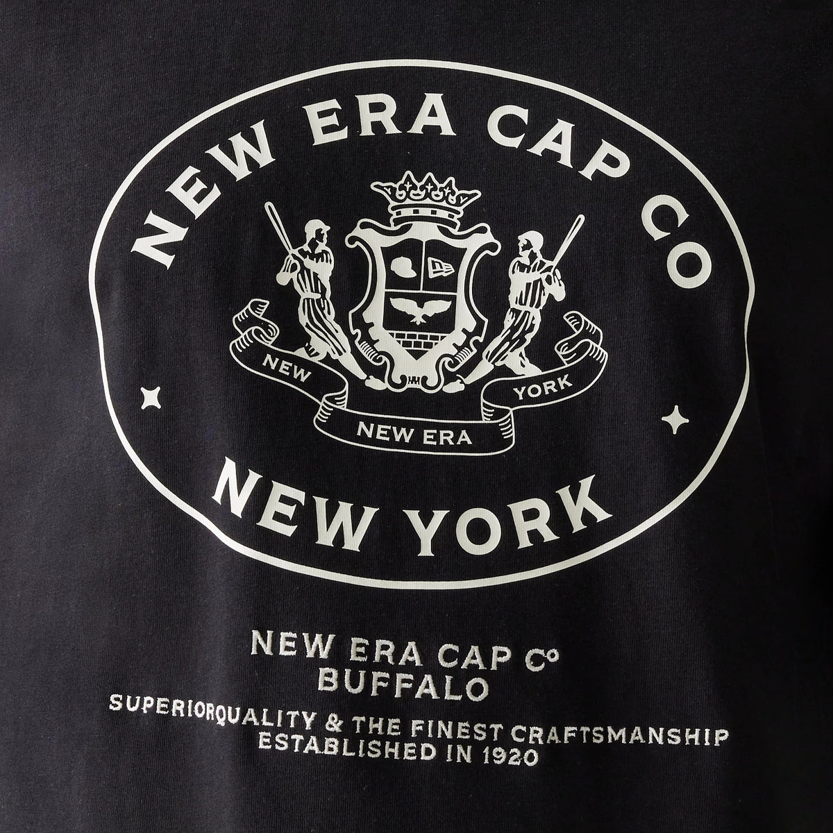 New Era Crest Black Oversized T-Shirt, front view showing a large white crest logo with intricate details including two figures and the words New Era Cap Co New York prominently displayed on the chest.