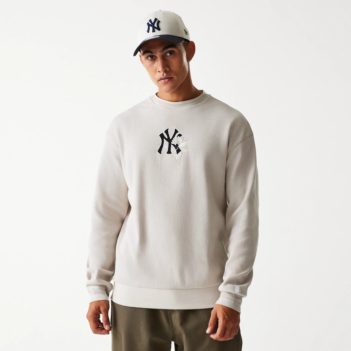 New Era New York Yankees MLB Waffle Cream Oversized Crew Neck Sweater, on-model showing the embroidered navy NY logo on the chest, paired with a matching cap featuring the same logo on the front panel.