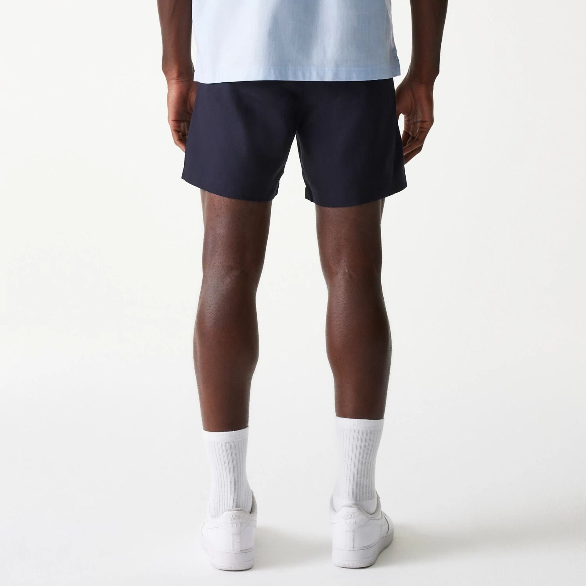 The Male model is wearing New Era Navy Chino Shorts 2