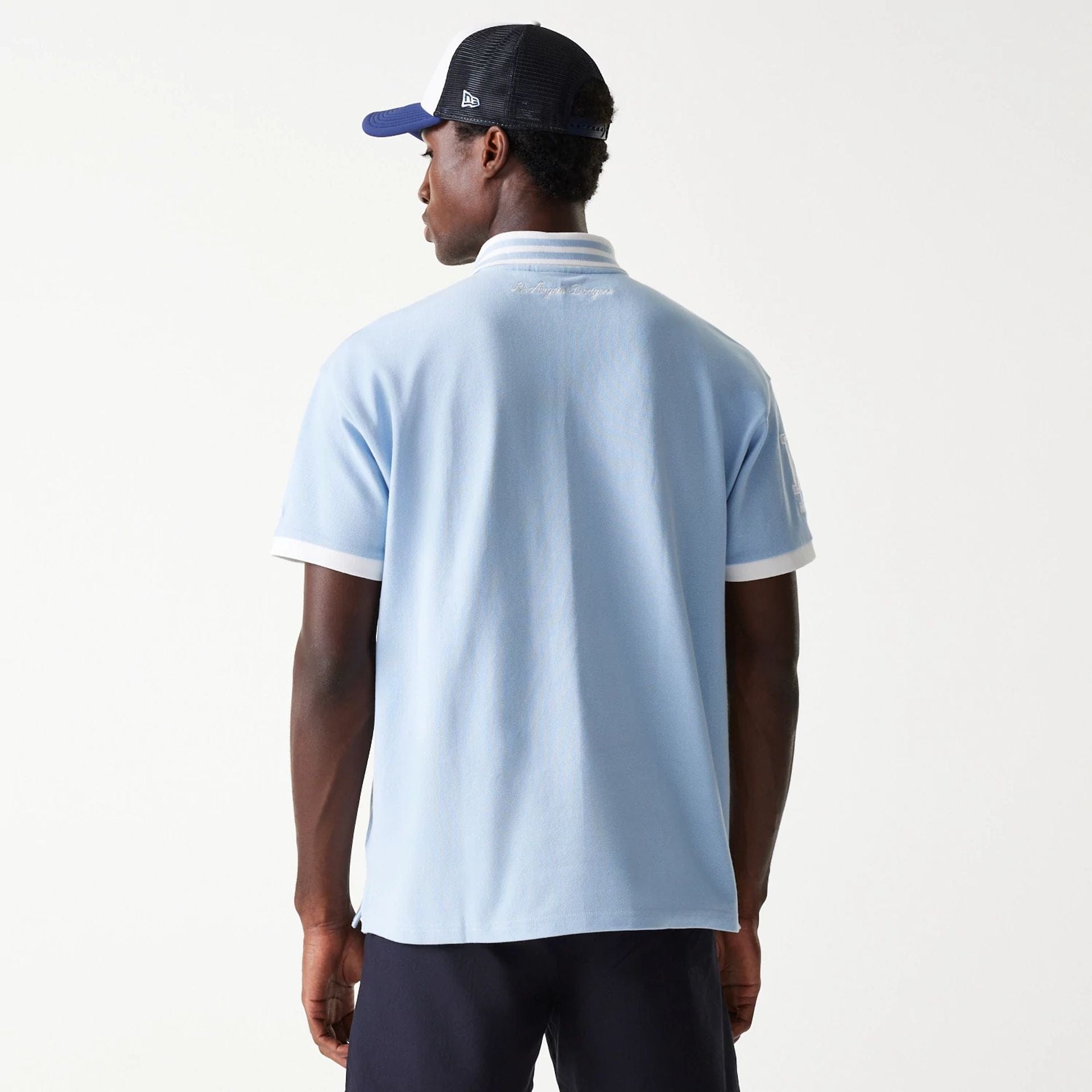 The Male model is wearing LA Dodgers MLB Graphic Pastel Blue Polo Shirt 2