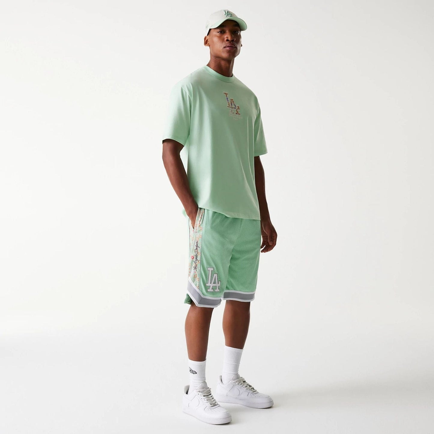 The Male model is wearing LA Dodgers MLB Infill Pastel Green Mesh Shorts 8