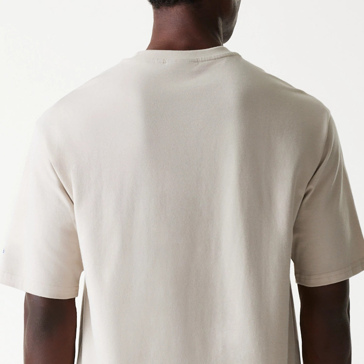 New Era LA Dodgers MLB Floral Graphic Cream Oversized T-Shirt, rear view showing a plain cream back with short sleeves, a rounded neck, and a small embroidered detail on the left sleeve.