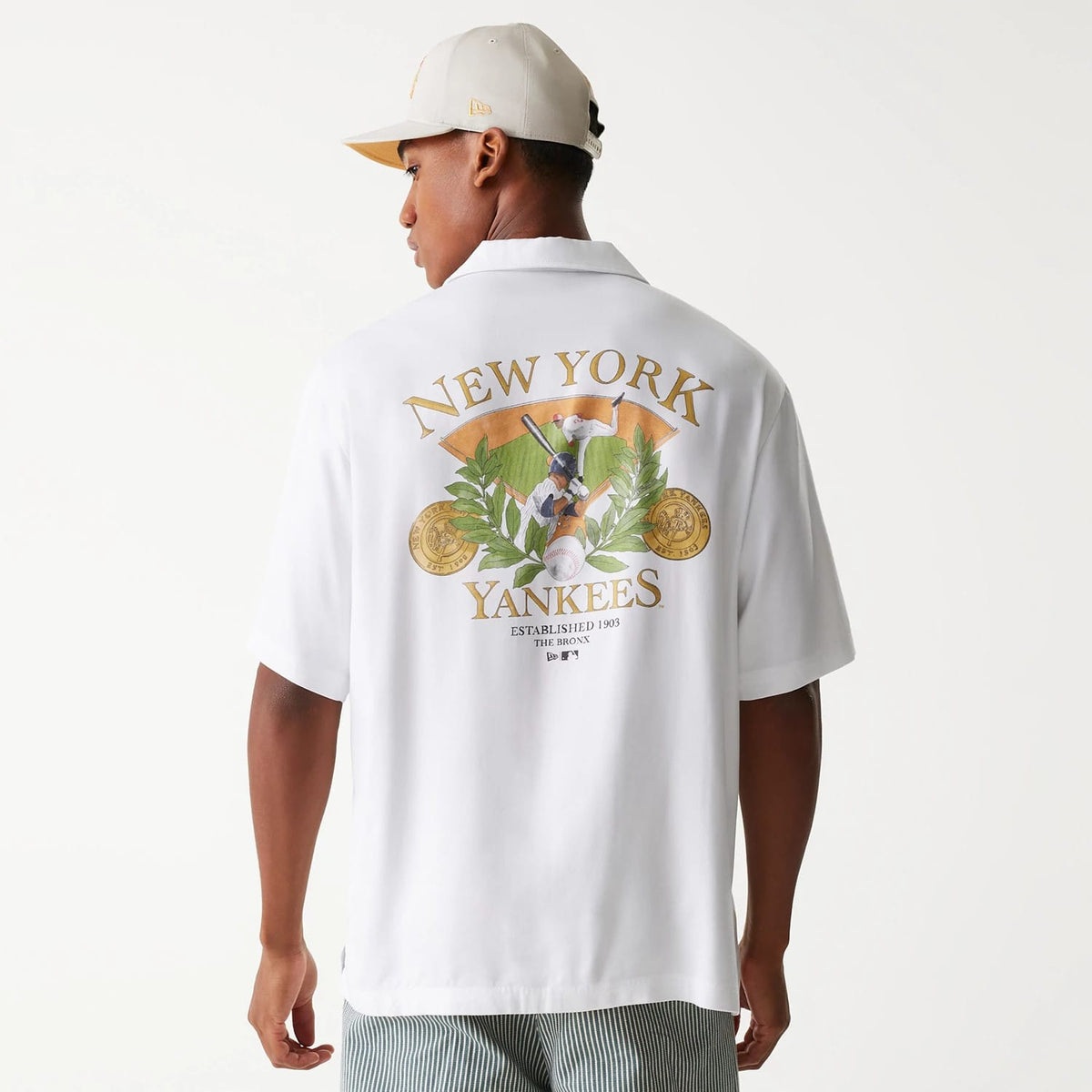 The Male model is wearing New York Yankees MLB Graphic White Revere Short Sleeve Shirt 2