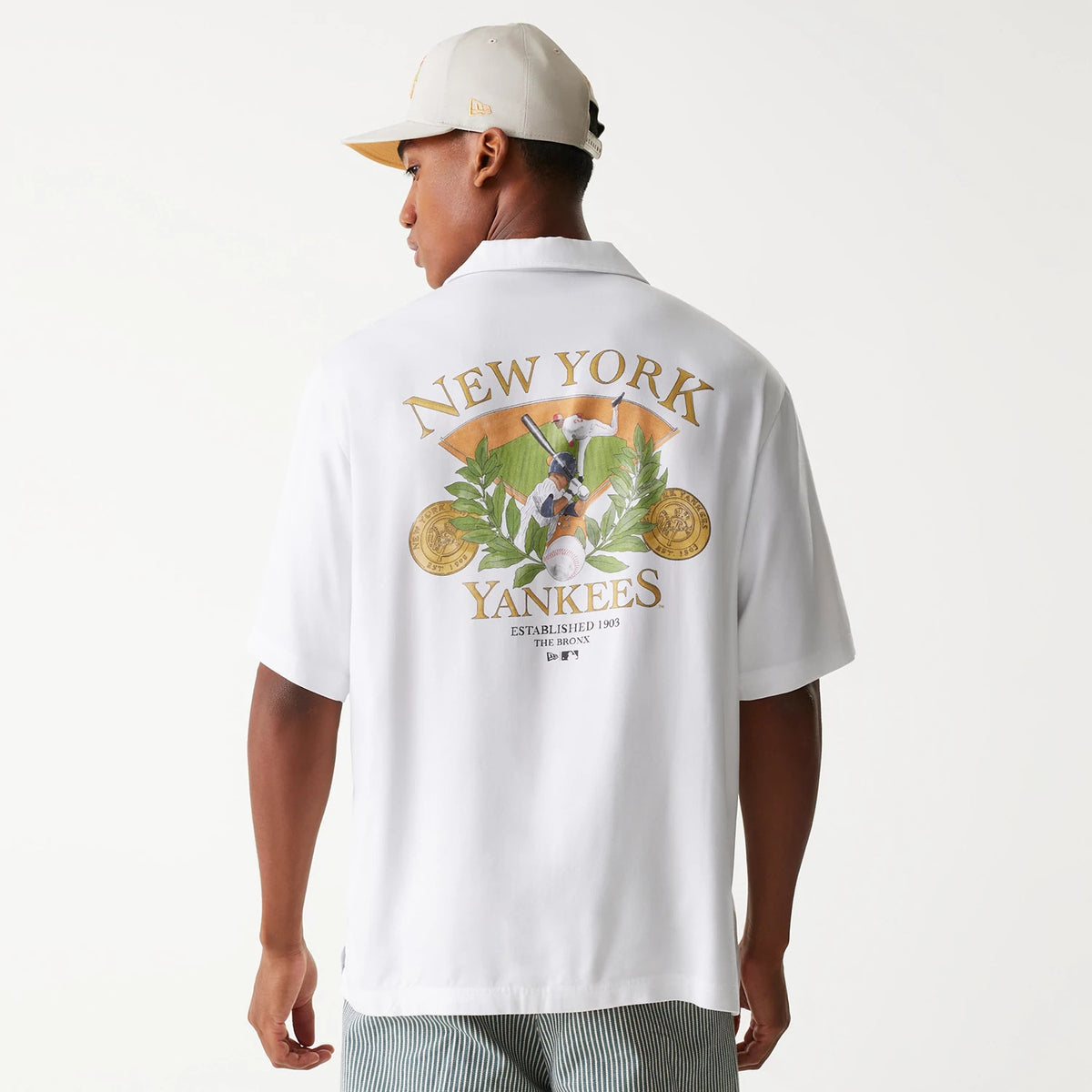 The Male model is wearing New York Yankees MLB Graphic White Revere Short Sleeve Shirt 2