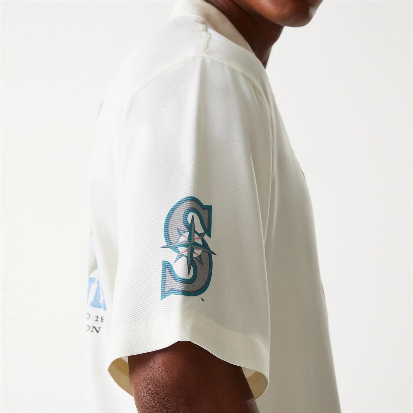 The Male model is wearing Seattle Mariners MLB Graphic Open White Revere Short Sleeve Shirt 7