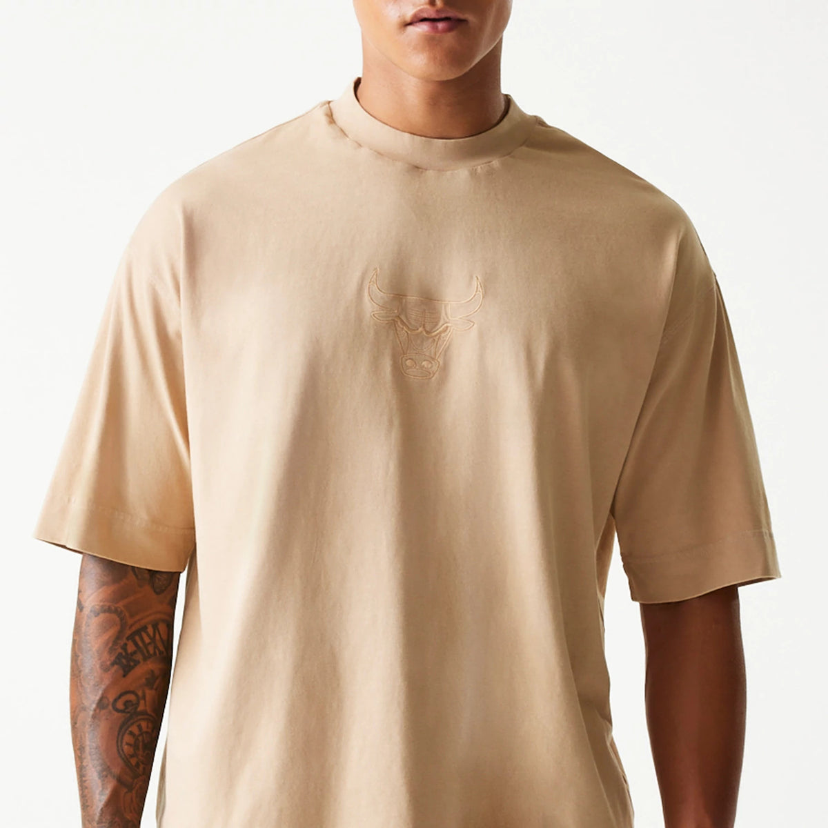 New Era Chicago Bulls NBA Washed Beige Box T-Shirt, front view showing a washed beige T-shirt with a large raised Chicago Bulls logo centred on the chest against a plain background, short sleeves and a round neckline.