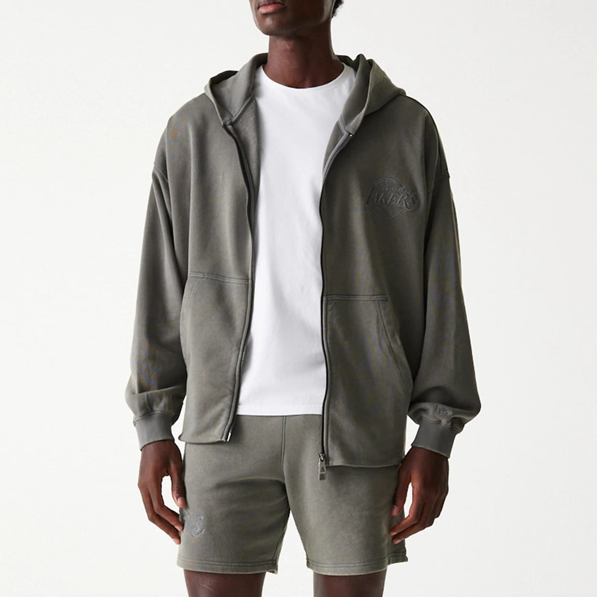 New Era LA Lakers NBA Washed Grey Full Zip Hoodie, on-model view showing the washed grey fabric with a raised LA Lakers logo on the left chest, a full zip closure down the centre, and a spacious hood resting on the shoulders.