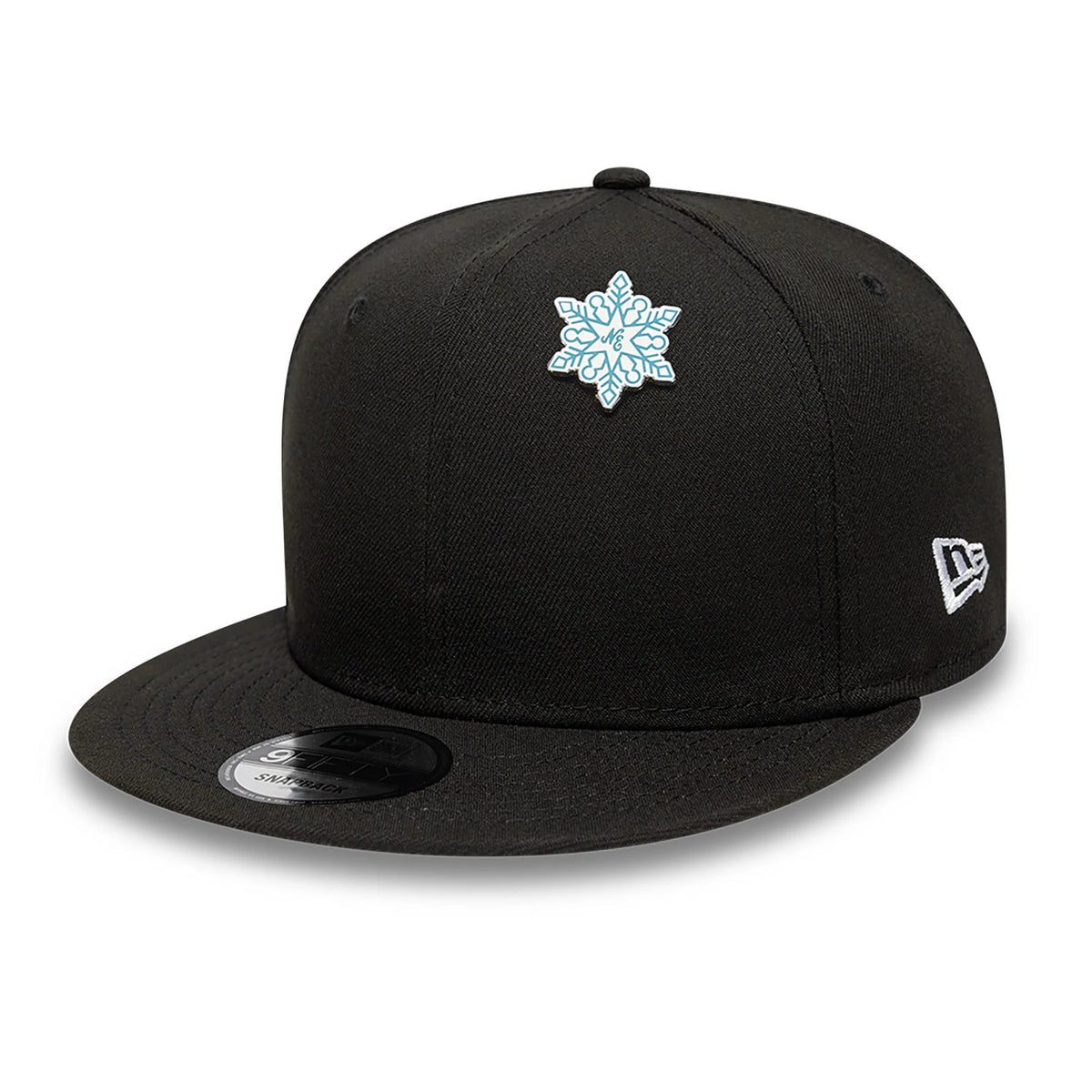 New Era Snowflake Blue Pin Badge, front view showing a black cap with a raised blue snowflake design on the front panel, a debossed New Era logo in white on the side, and eyelets on the top panels.