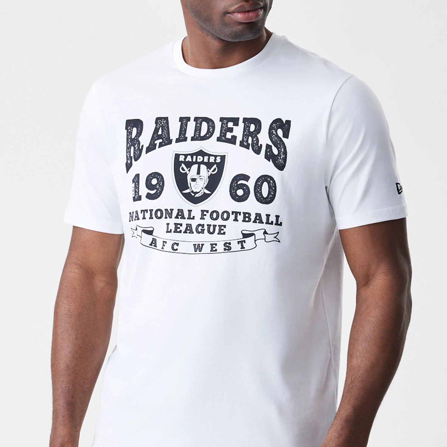 New Era Las Vegas Raiders NFL Stack Arch Logo White T-Shirt, front view showing large black Raiders logo and text design across the chest, short sleeves with a small embroidered New Era logo on the left sleeve.
