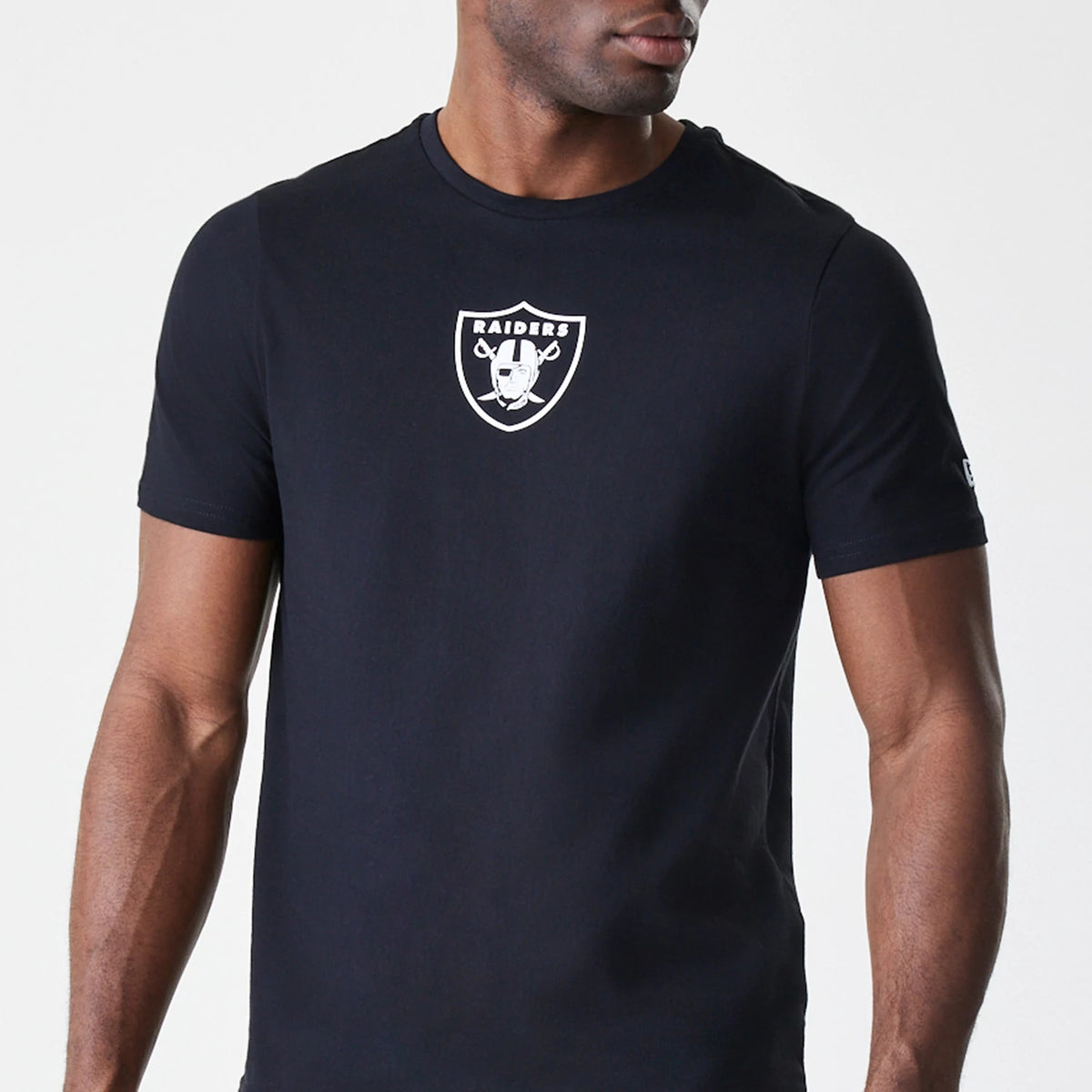 New Era Las Vegas Raiders NFL Logo Black T-Shirt, front view showing a white raised Raiders shield logo centred on the chest, with short sleeves and a round neckline on a black cotton tee.